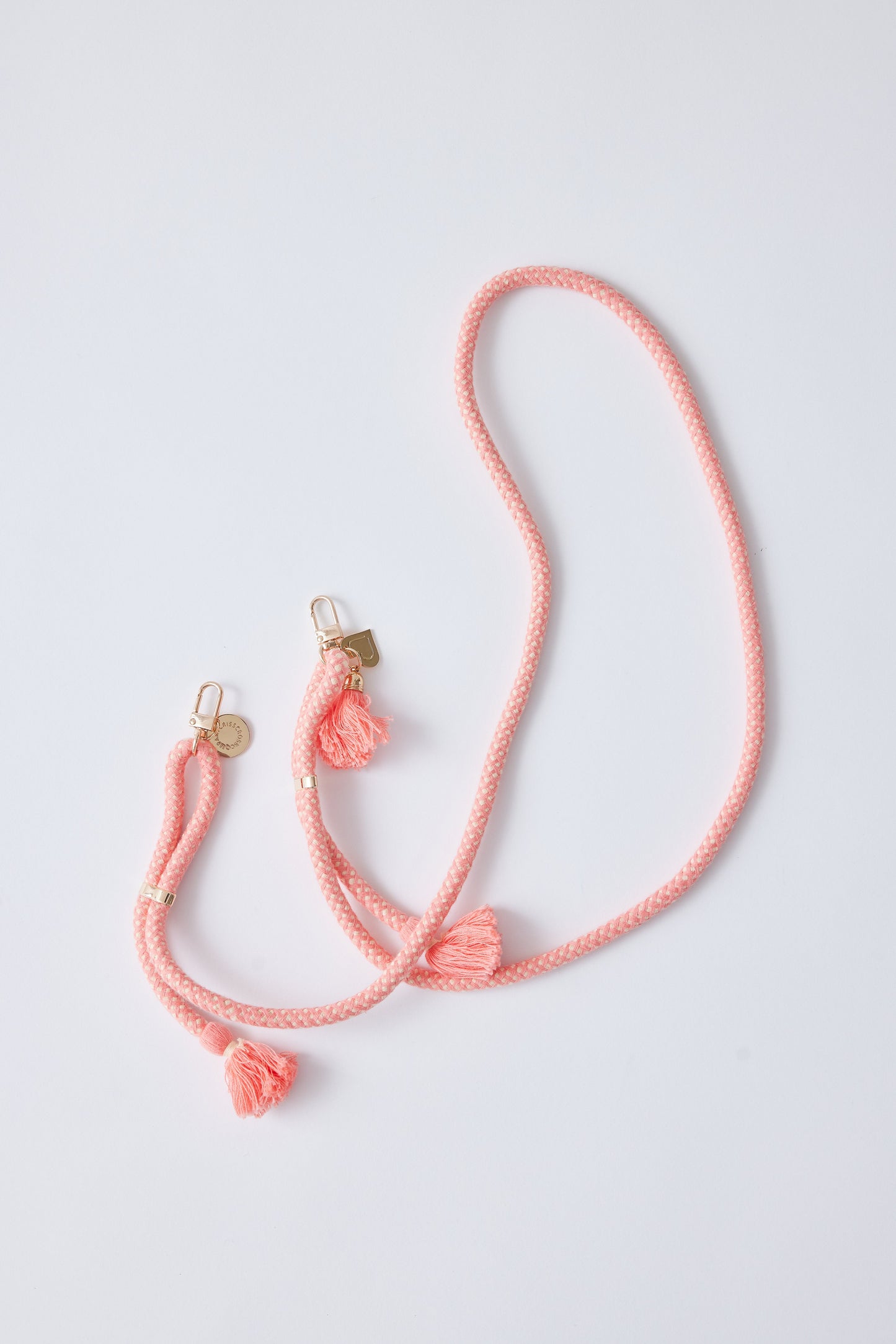 Detachable cotton phone strap with double carabiners and tassels.