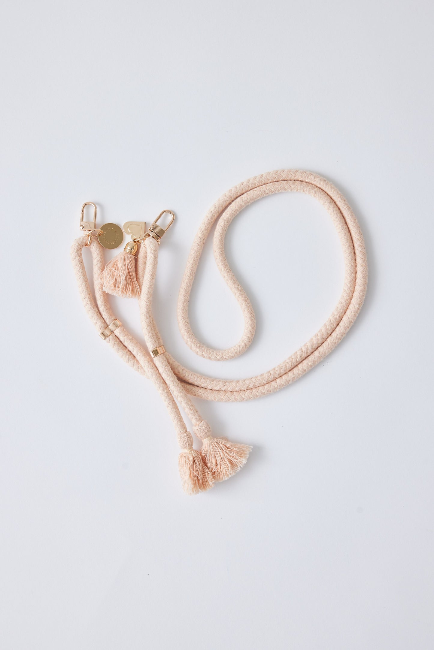 Detachable cotton phone strap with double carabiners, tassels, and heart charm.
