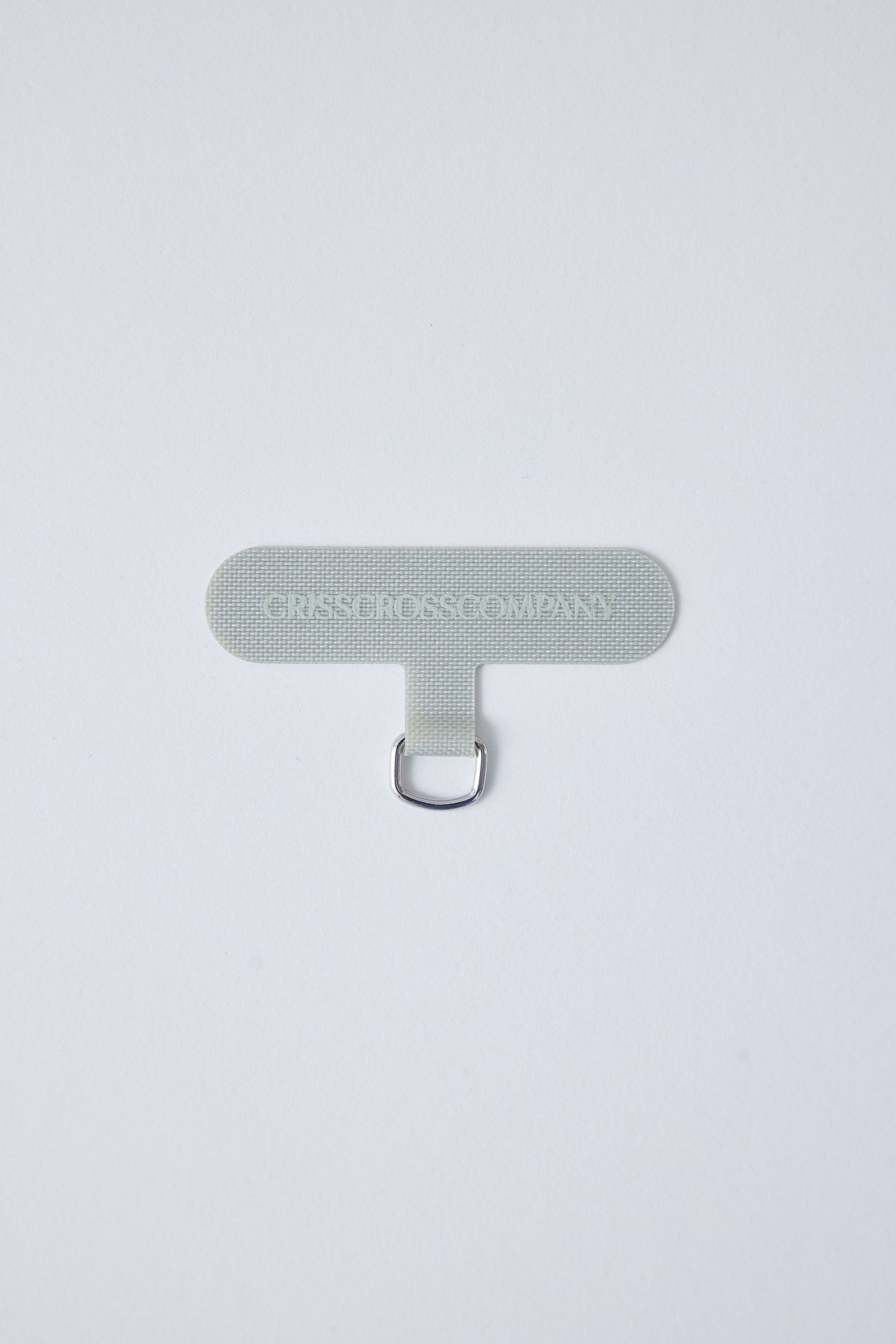 Single Universal Phone Adapter in gray with ring attachment for straps or chains.