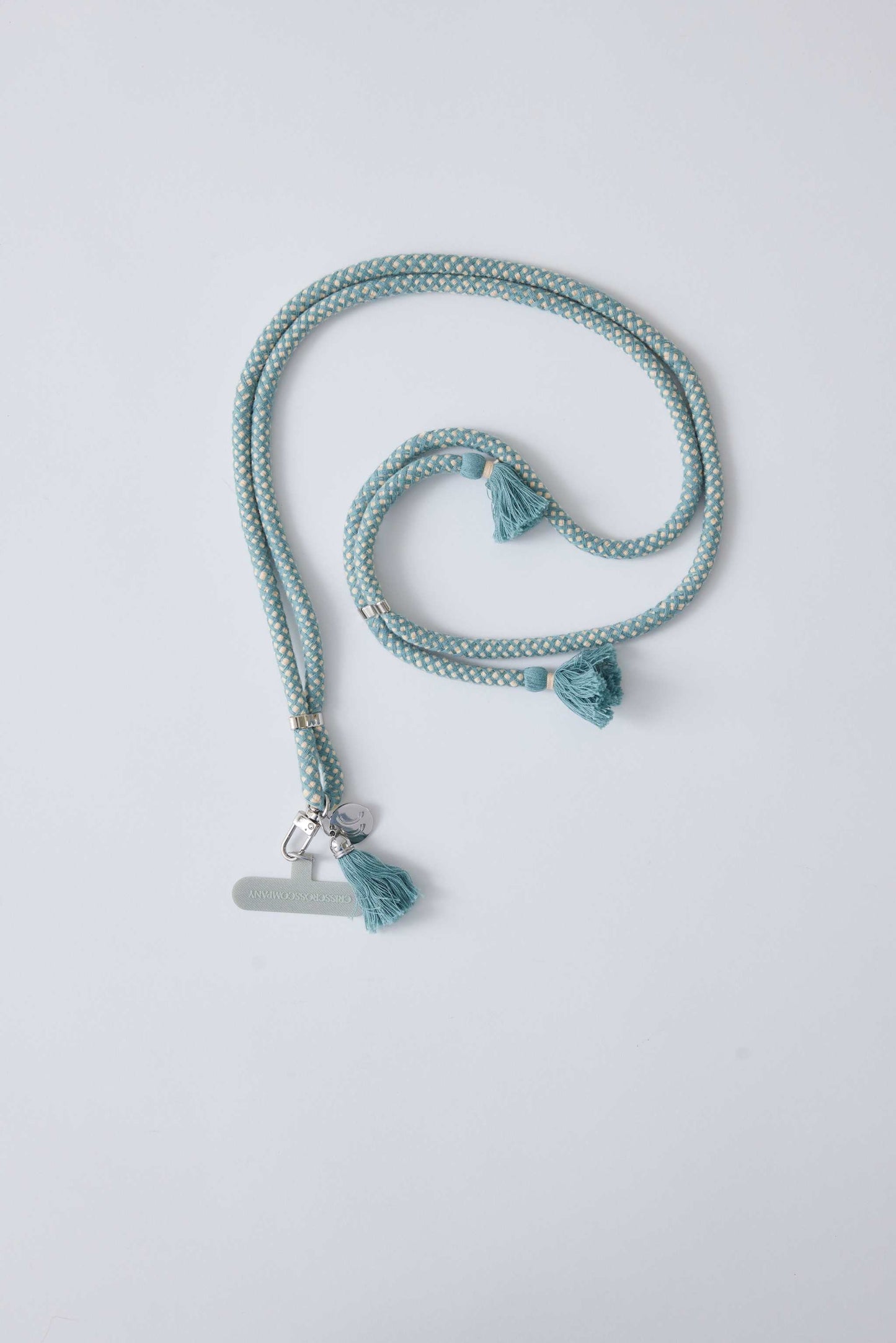 Cotton phone strap with universal adapter and adjustable length, featuring tassels and silver carabiner.