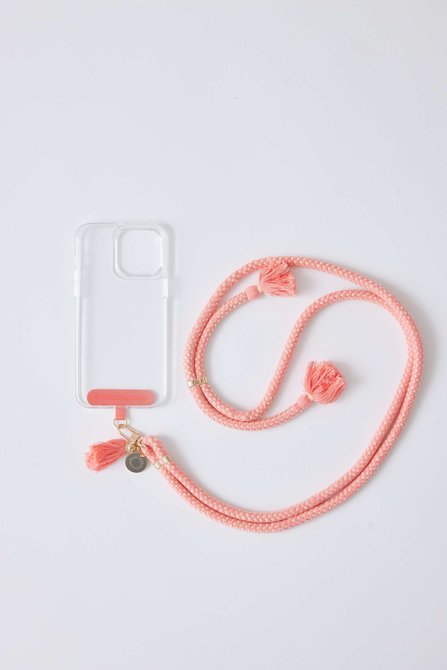 Cotton phone straps with universal adapter, pink color, adjustable length, attached to phone case.