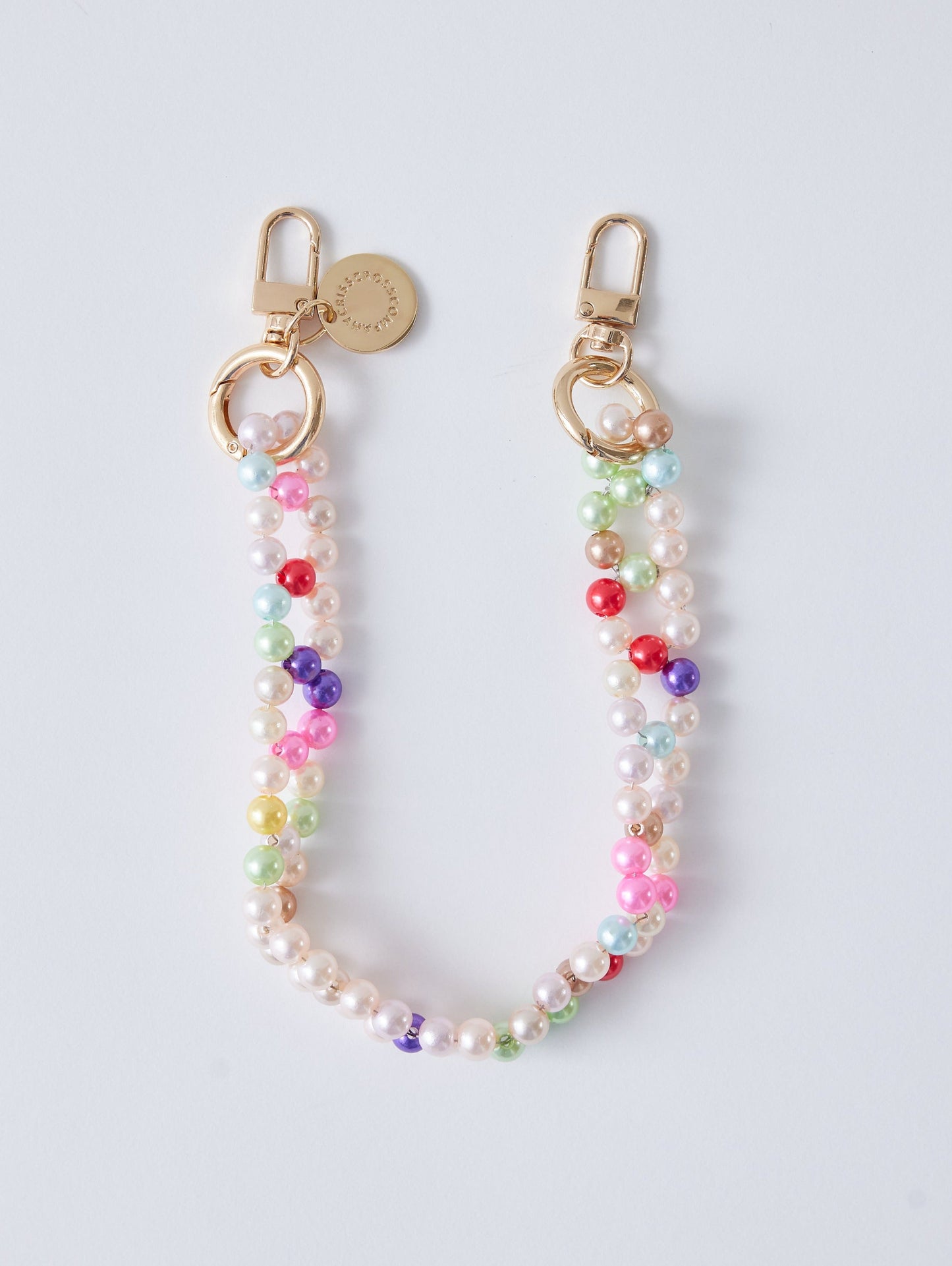 Detachable candy wristlet with colorful beads and gold clasps.