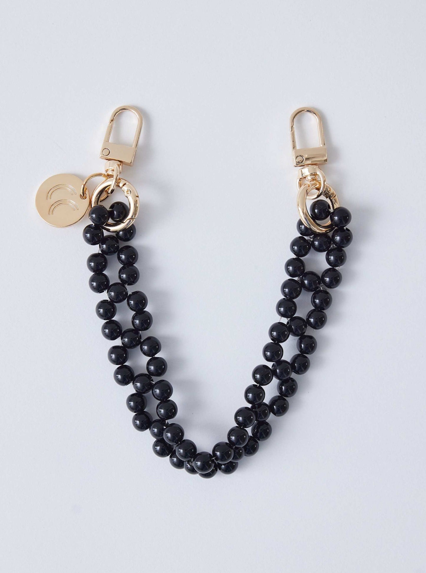 Detachable beaded wristlet with black beads and gold clasps.