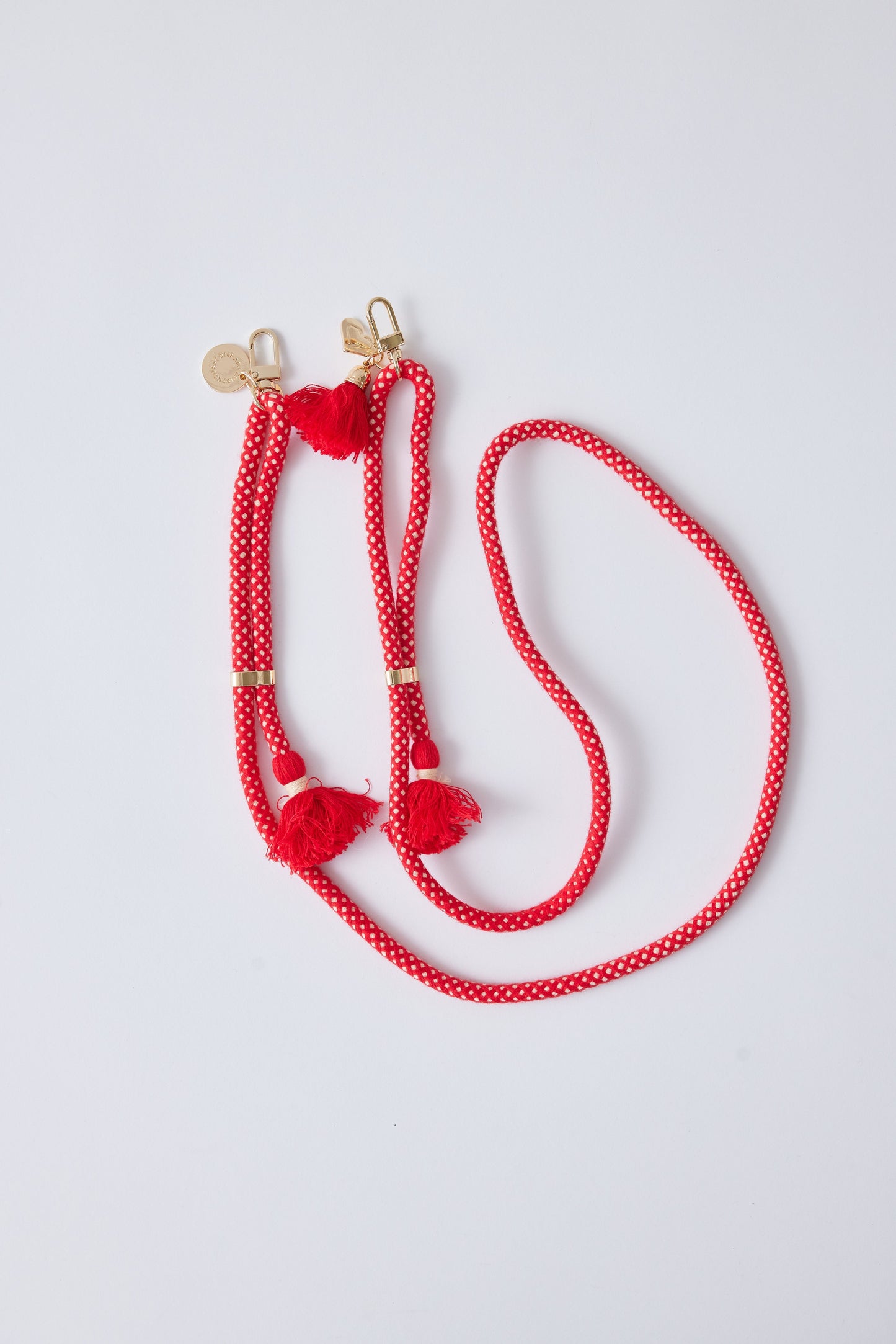 Detachable cotton phone strap with double carabiners, red tassels, and heart charm.