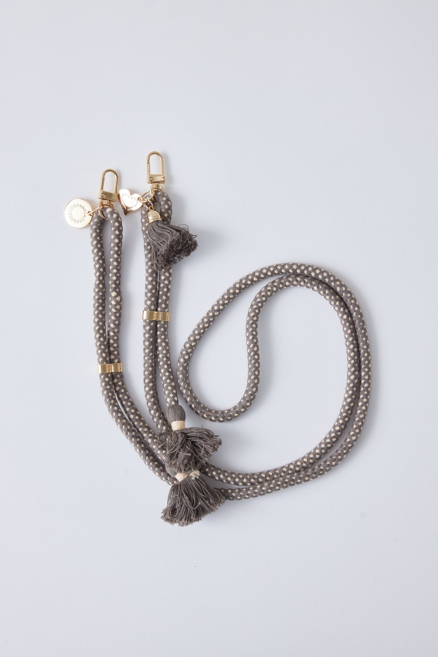 Detachable cotton phone strap with double carabiners, tassels, and heart charm.