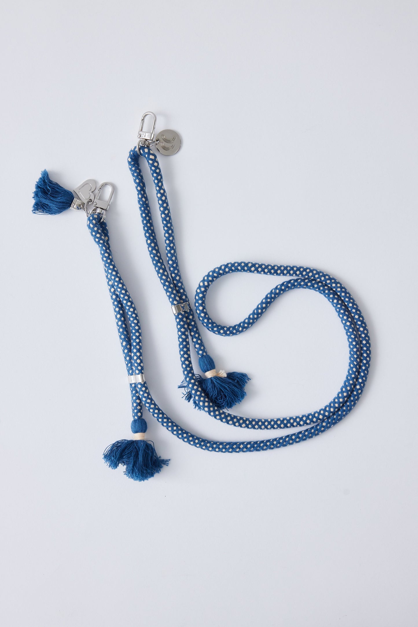 Detachable cotton phone strap with double carabiners, tassels, and heart charm, blue with silver hardware.