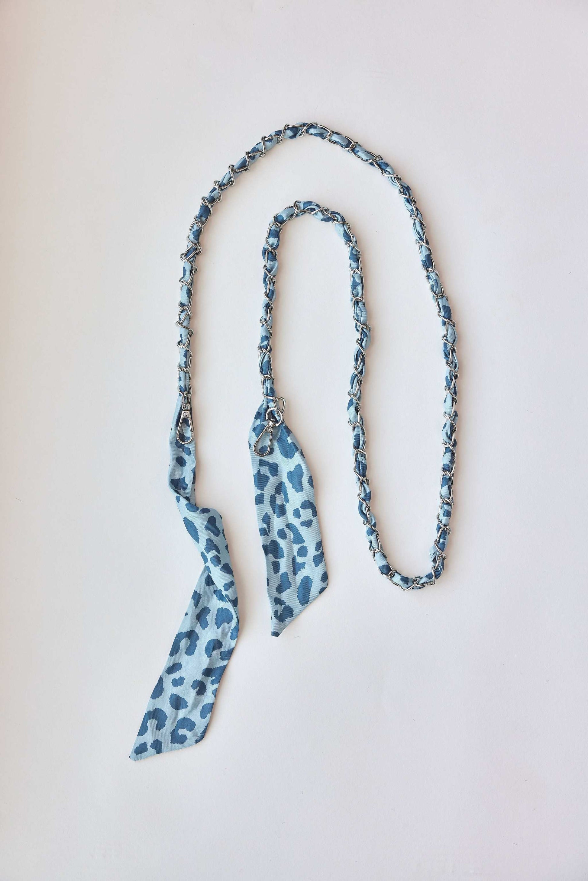Denim Leo Chain with blue leopard print and carabiner attachments.