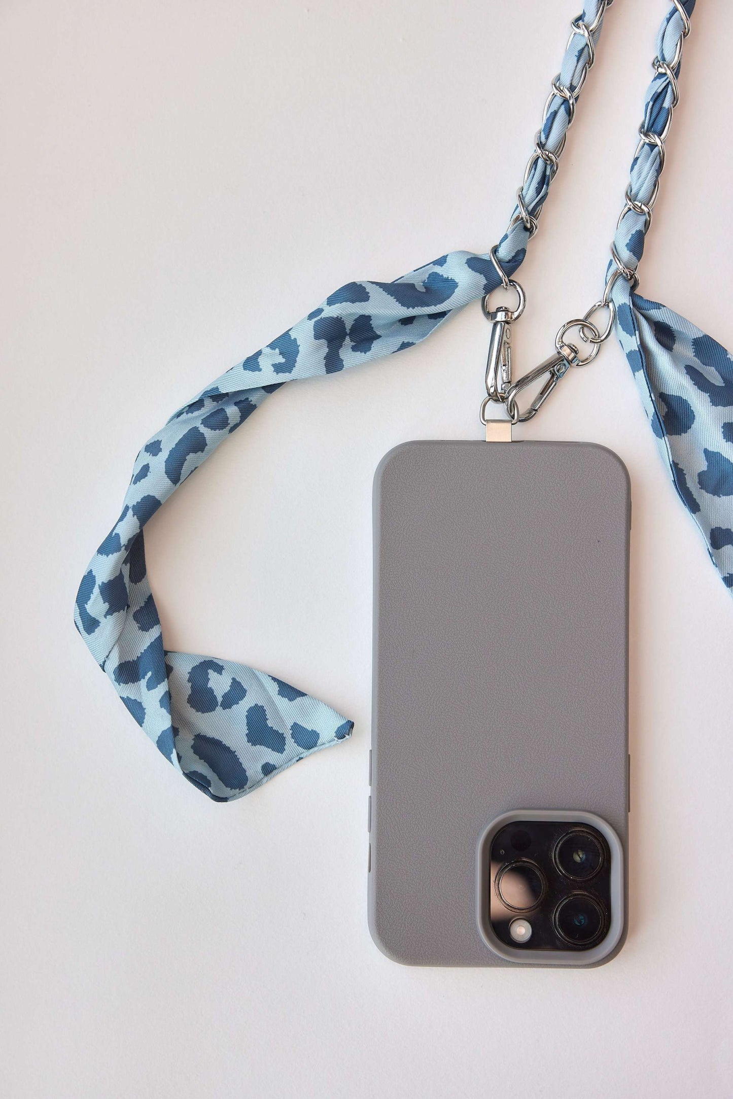 Denim Leo Chain attached to phone case with carabiners.