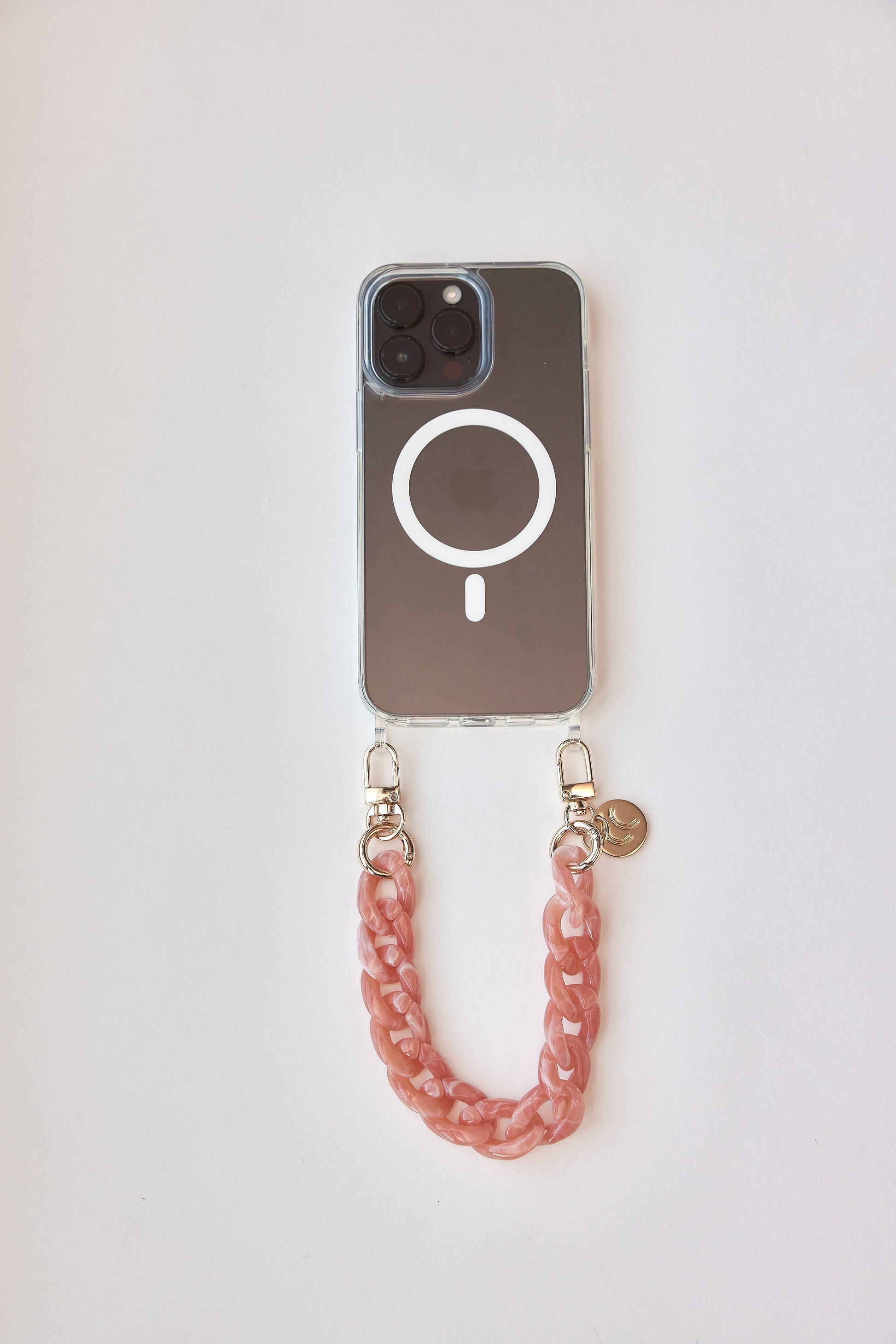 Detachable phone wristlets with pink chain attached to smartphone case.