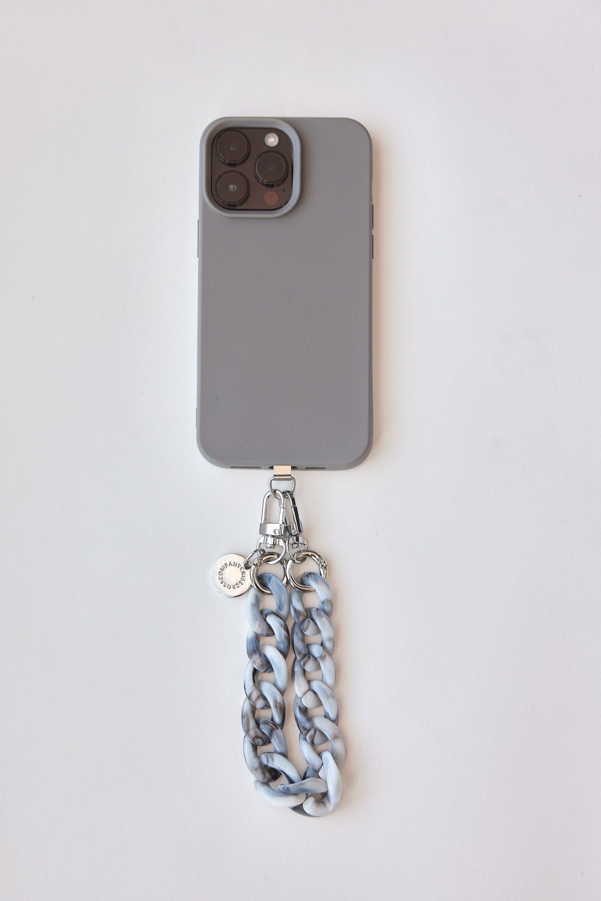 Detachable phone wristlet with colorful design attached to a smartphone.