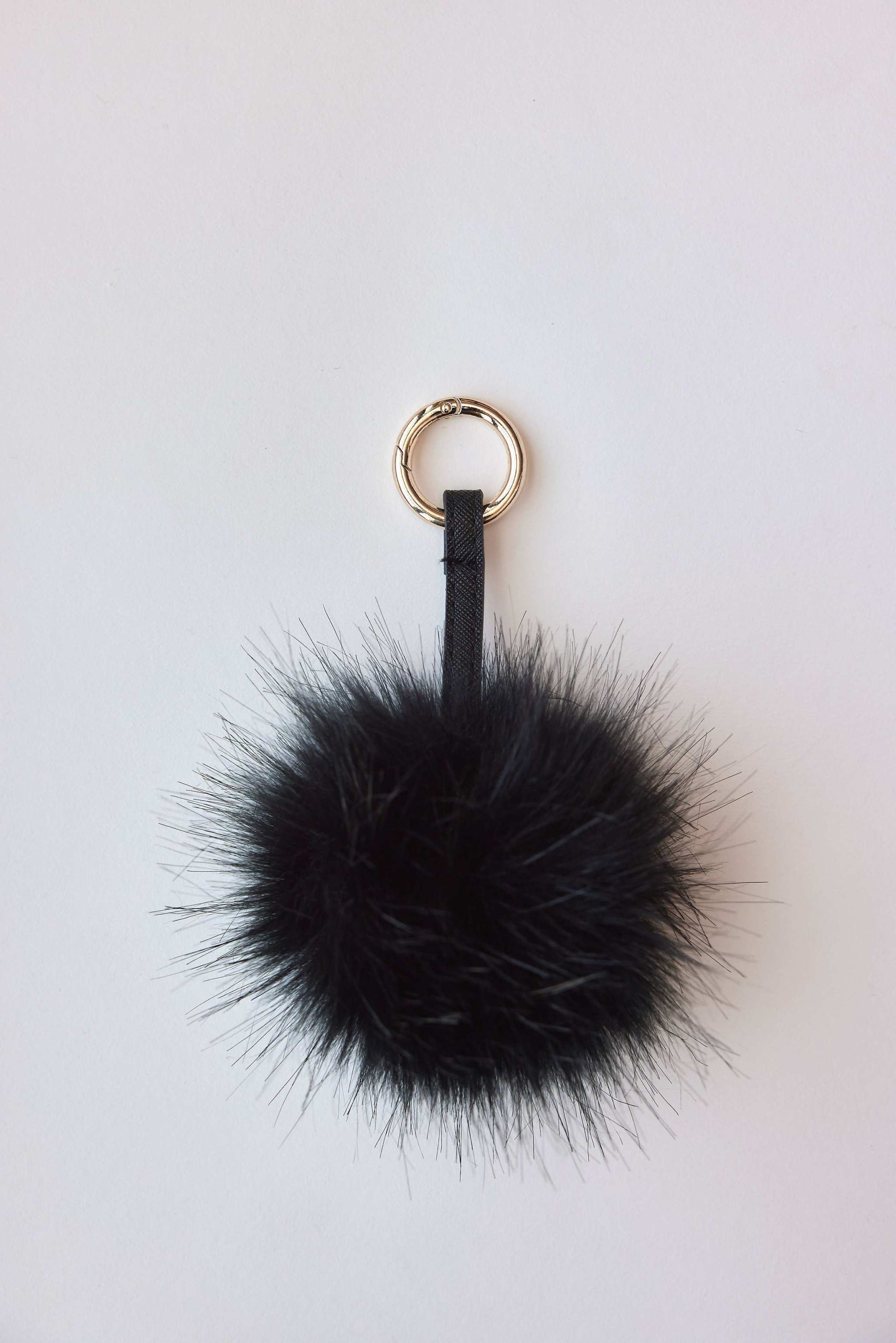 faux fur pom-pom accessory in black with keychain attachment