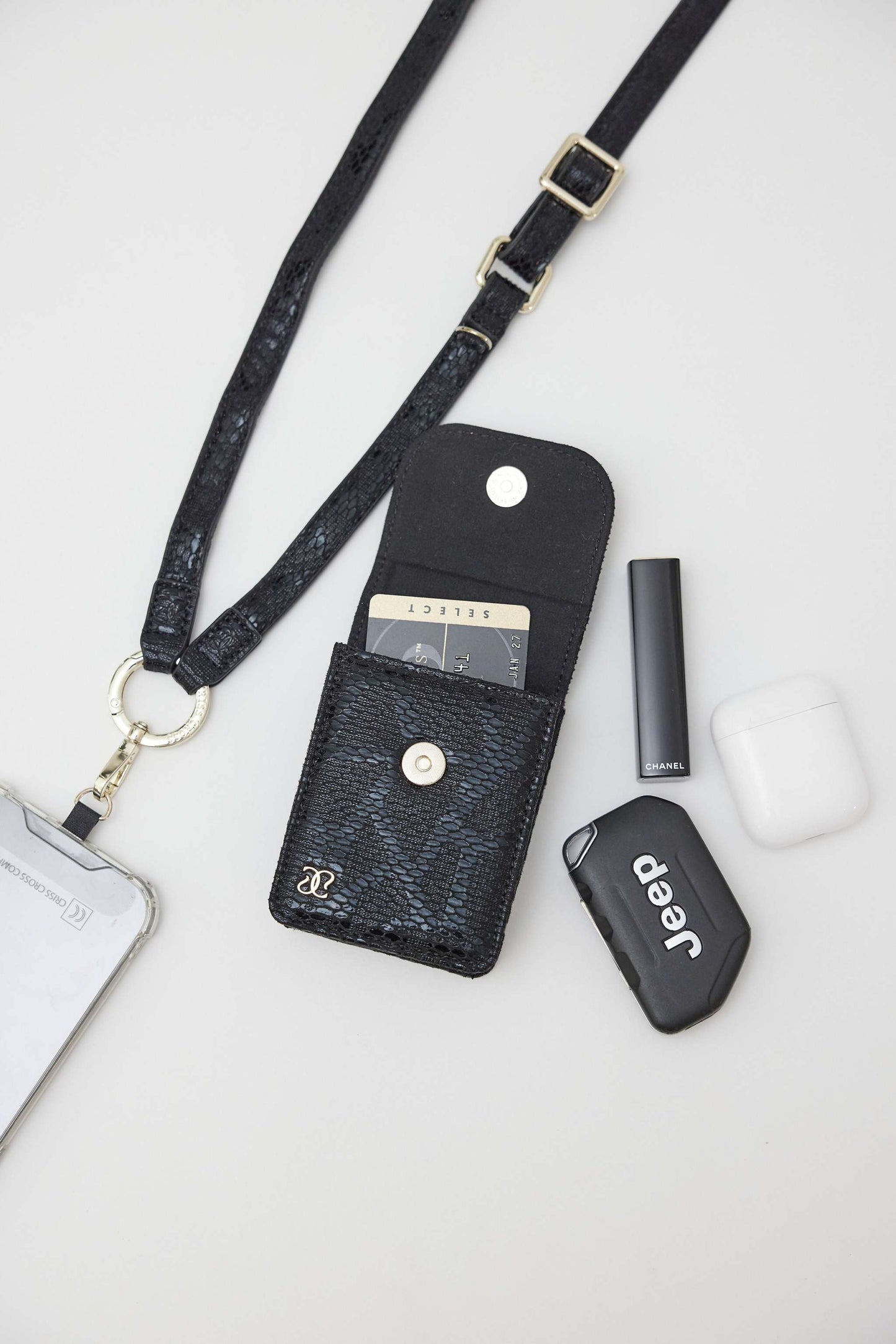 Cobra vegan leather strap with clip wallet and phone holder in chic snake design, adjustable for hands-free use.