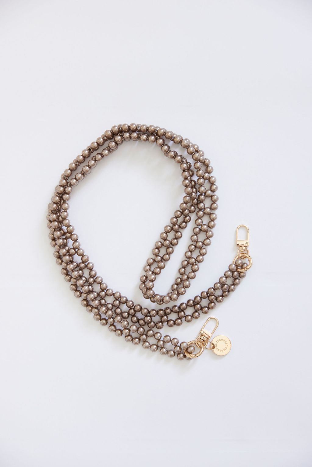 Detachable beaded chains with golden rings and carabiners in beige/brown.