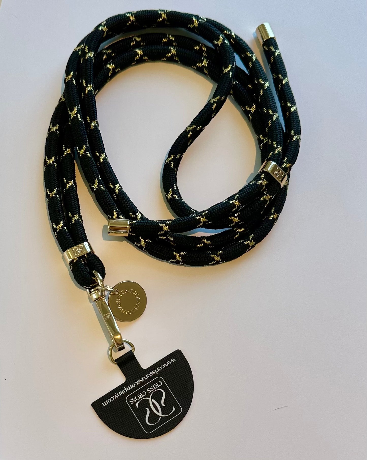 Goldline Phone Strap with durable woven gold-thread design and universal adapter attached to phone