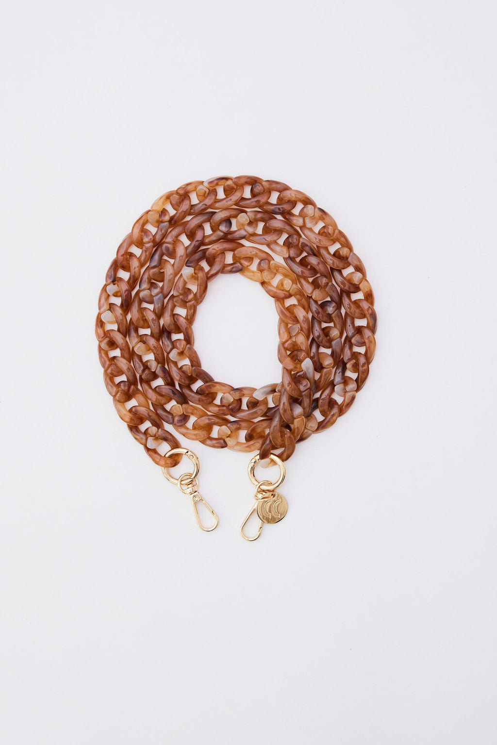 Detachable acrylic phone chain with golden rings and carabiners.