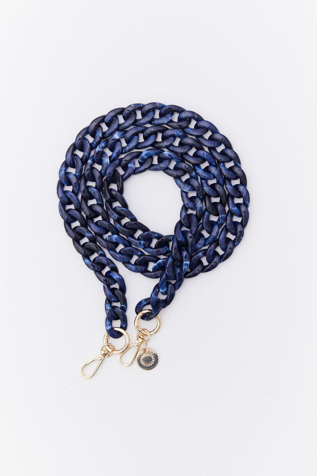 Detachable acrylic phone chain with golden rings and carabiners.