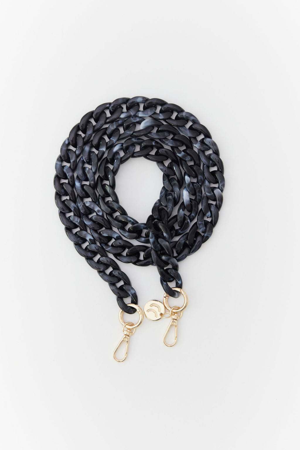 Detachable acrylic phone chain with golden rings and carabiners.