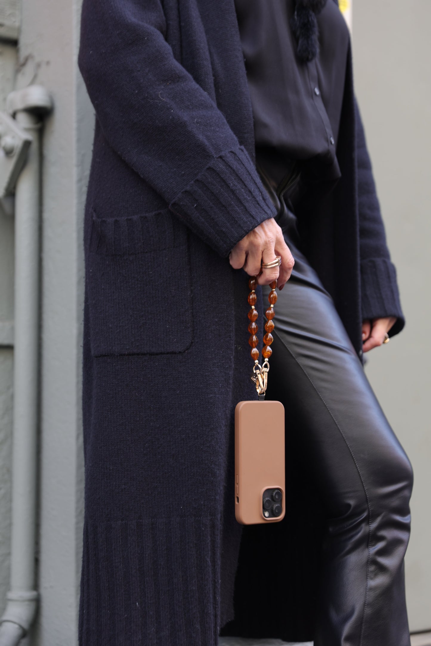 Brown beaded phone wristlet with acrylic beads and universal adapter for stylish phone carrying