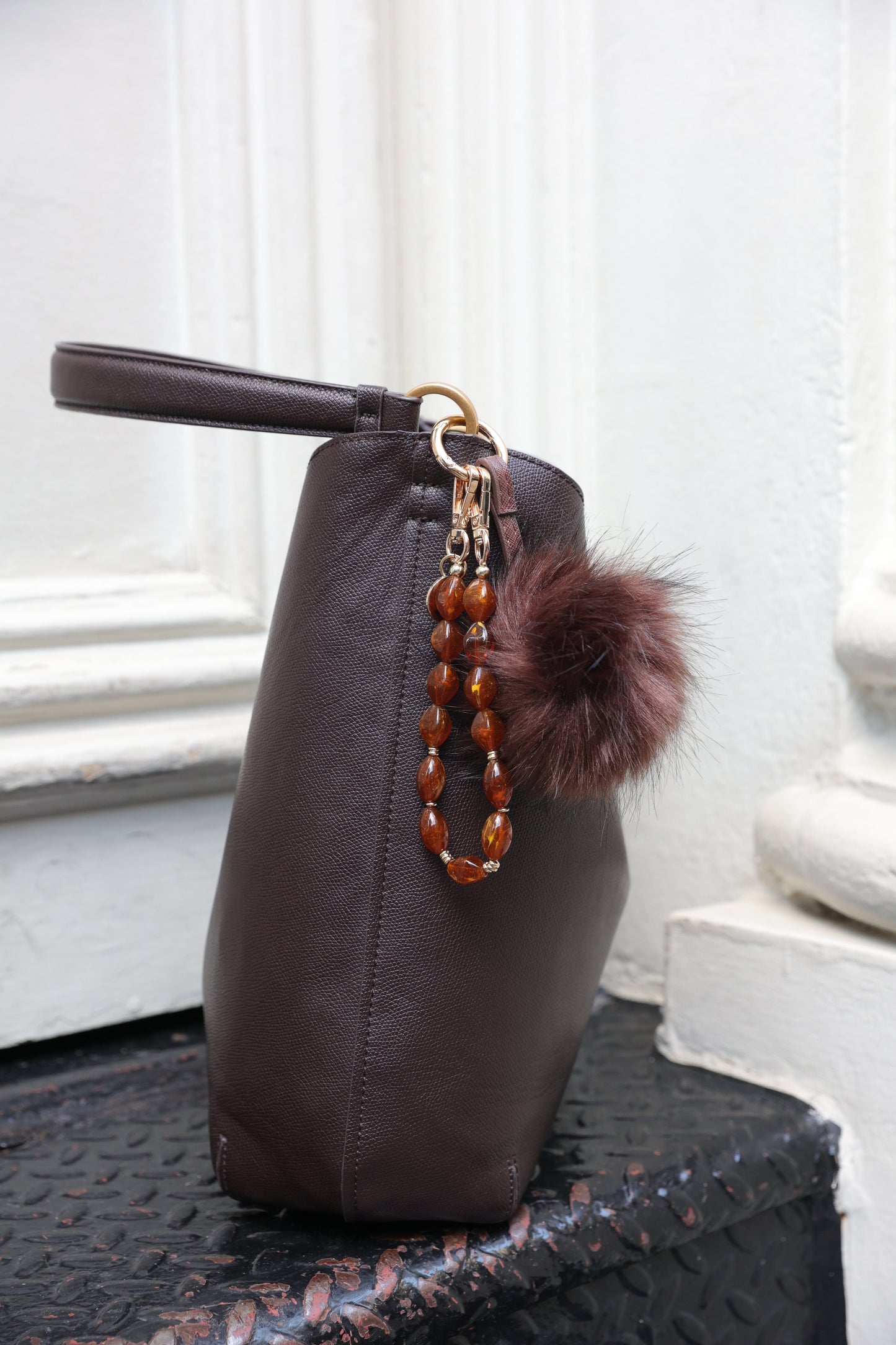Brown beaded phone wristlet with acrylic beads and universal charging port adapter