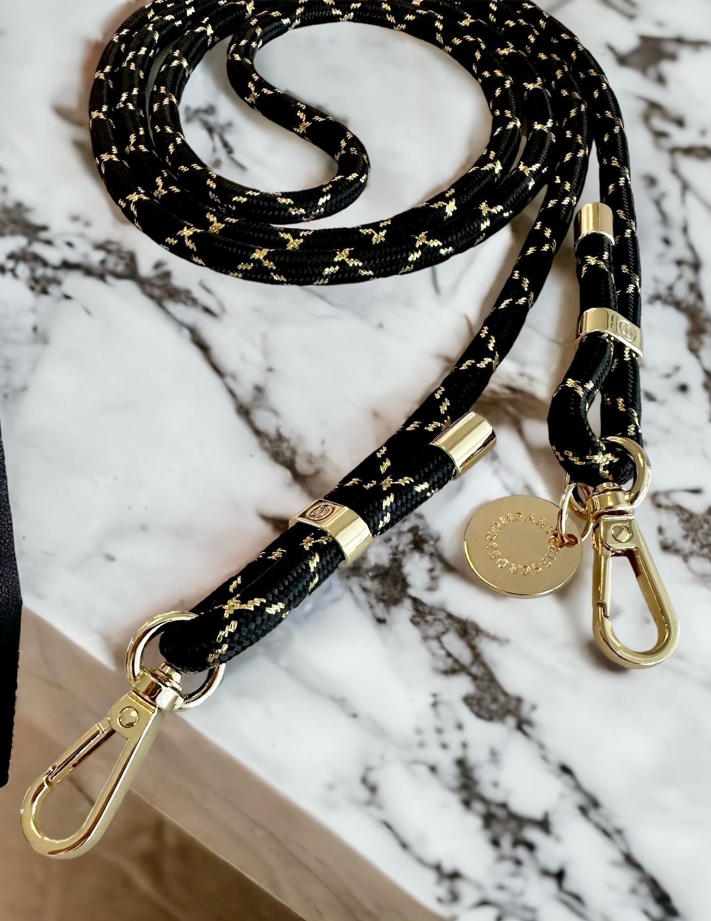 Detachable poly straps with gold carabiners, polyester material, adjustable length.