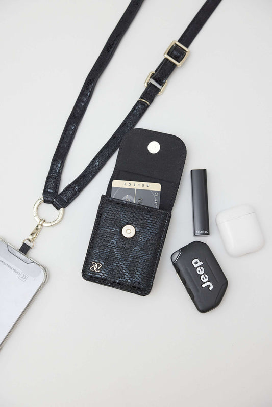 Cobra vegan leather strap with clip wallet and phone holder in chic snake design, adjustable for hands-free use.