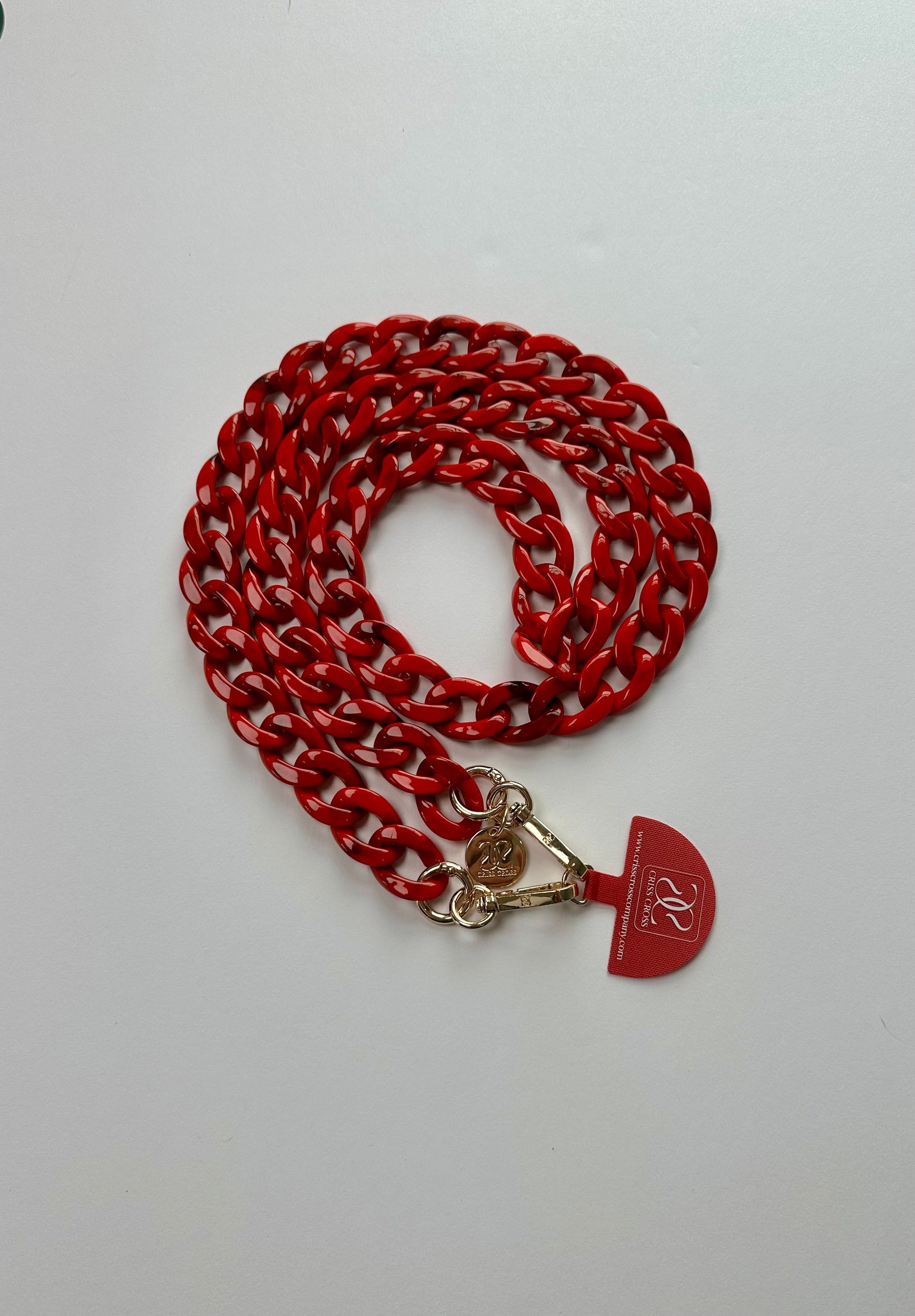 Detachable acrylic phone chain with universal adapter and alloy carabiners attached to smartphone case