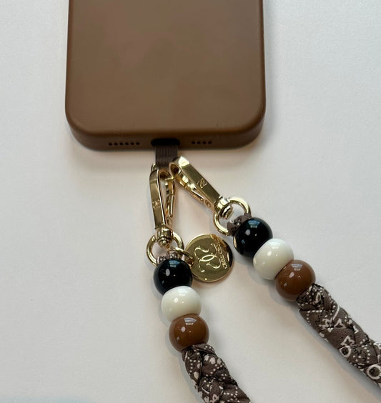 Bandana phone straps with cotton pattern, beads, and universal adapter attached to phone case