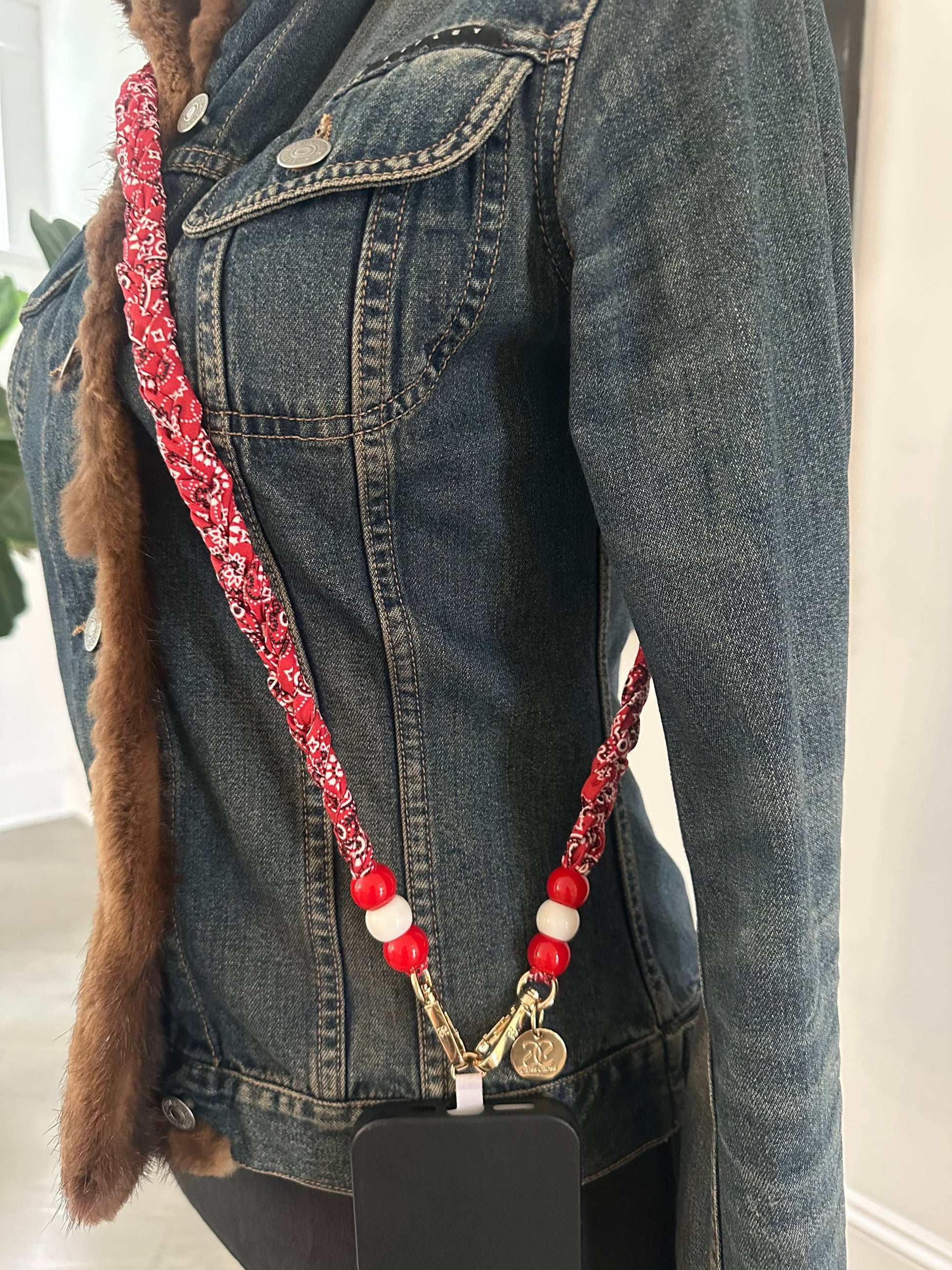 Red bandana phone strap with beads worn with denim jacket
