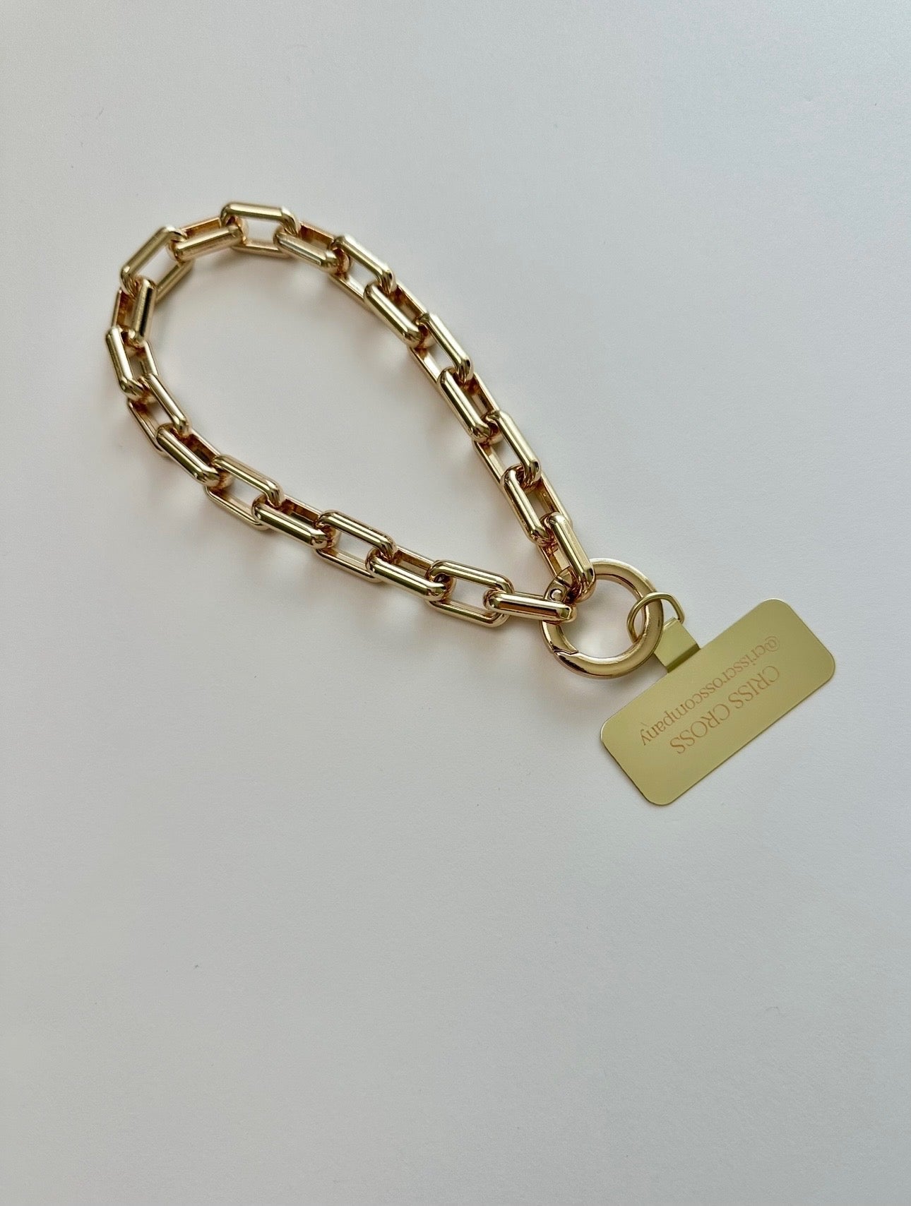 Gold Wristlet Ava phone accessory with universal adapter and gold-tone alloy links