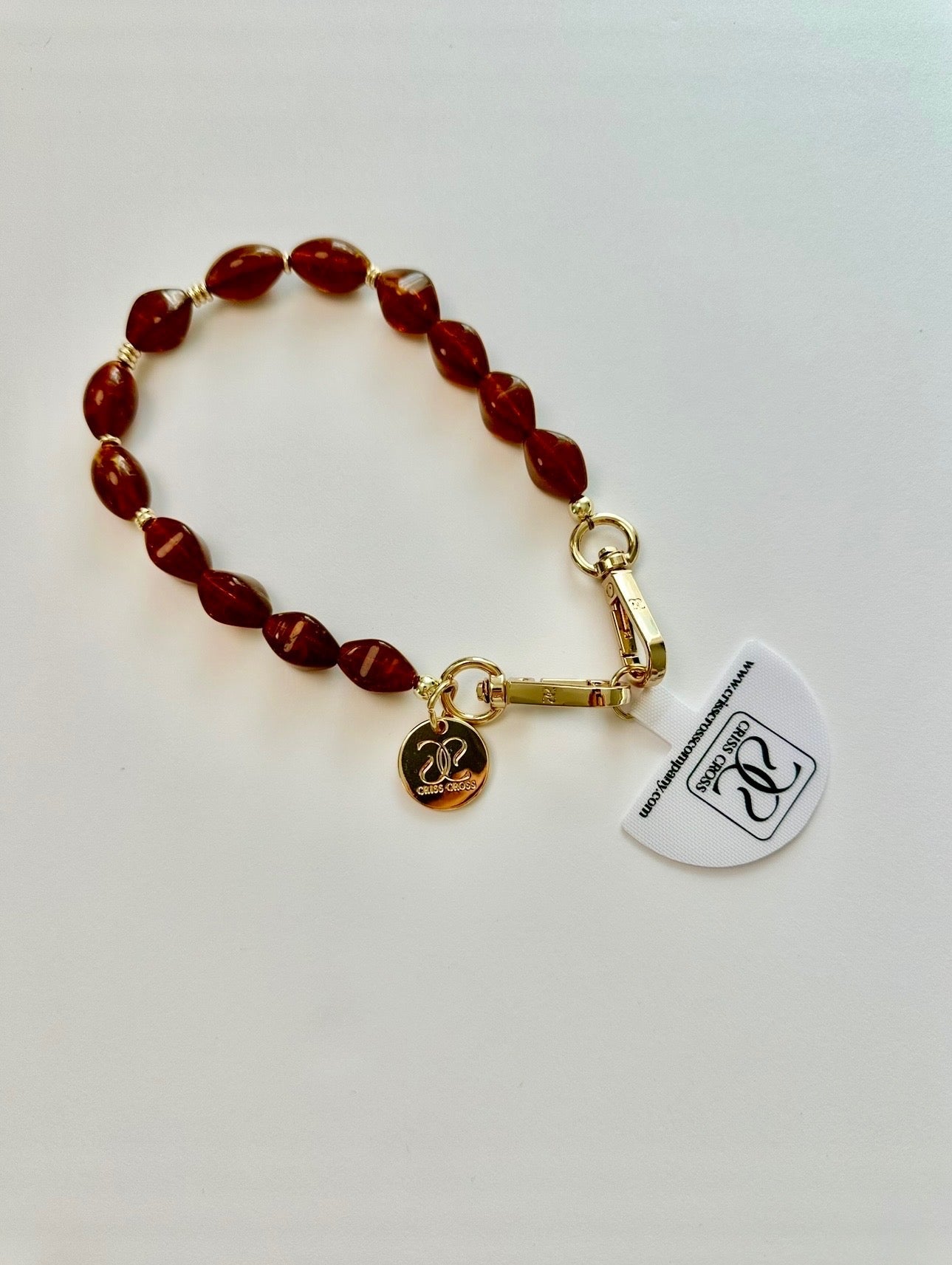 Brown beaded phone wristlet with acrylic beads and universal adapter attached to phone case
