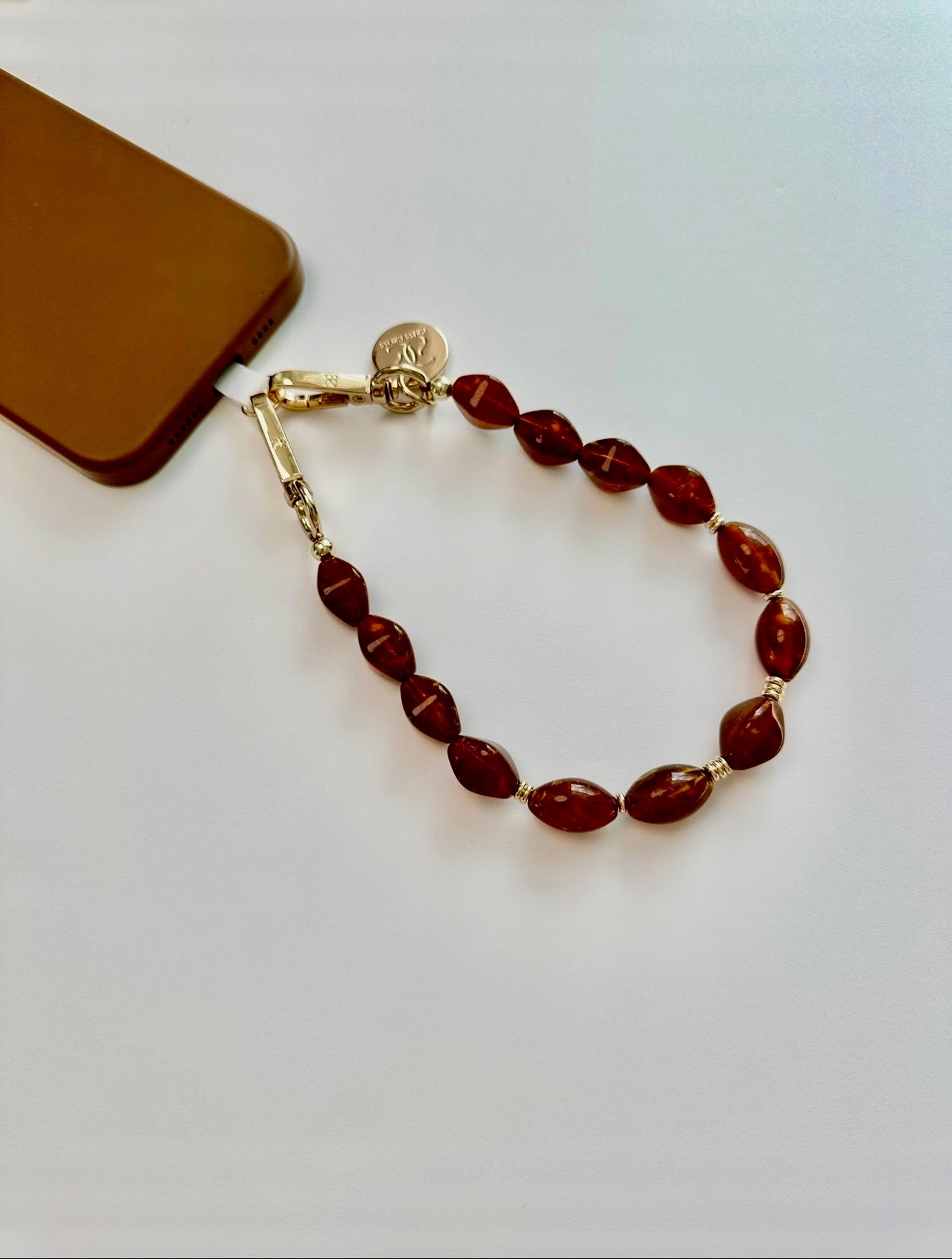 Brown beaded phone wristlet with acrylic beads and universal charging port adapter