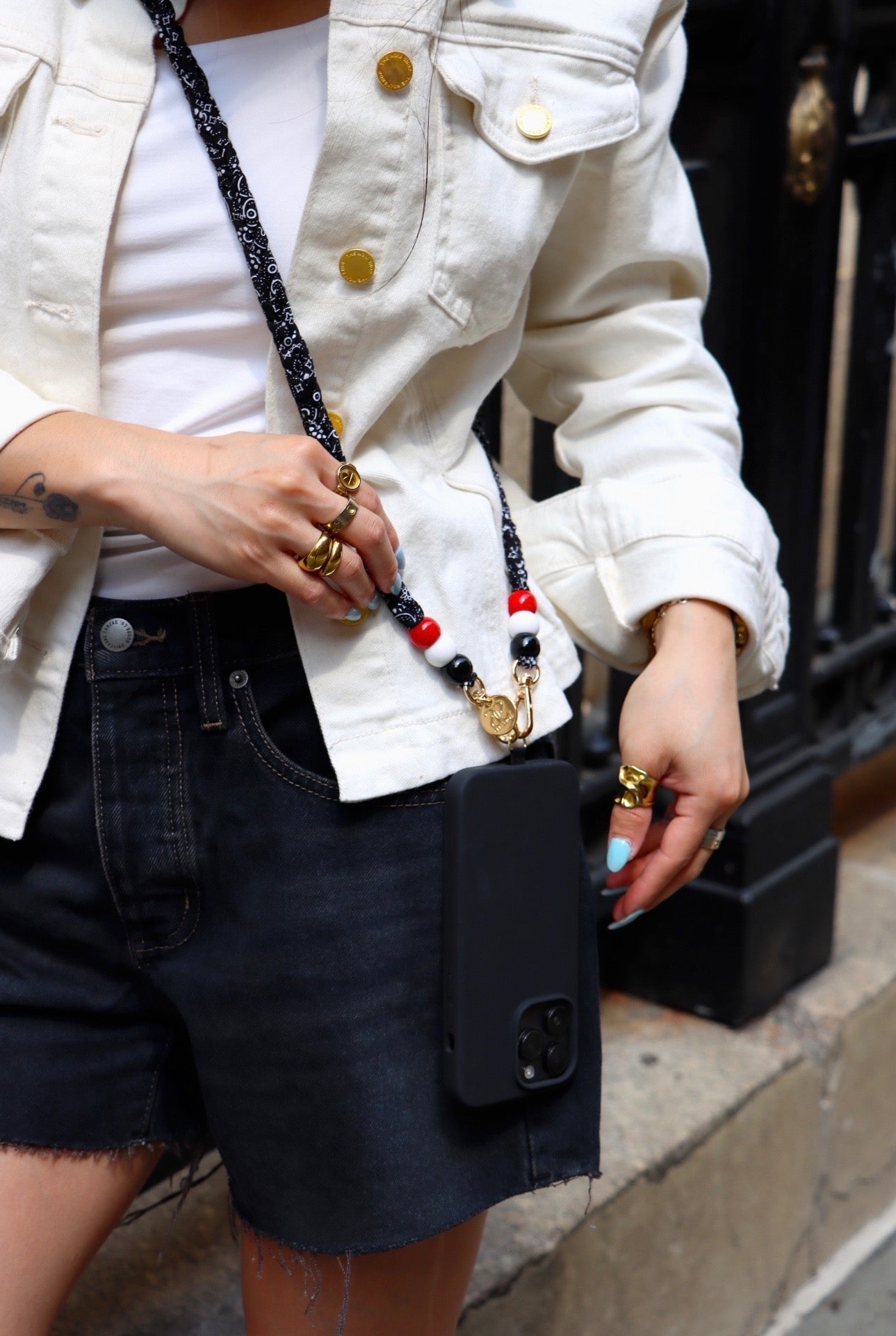 Bandana phone strap with cotton pattern, beads, and universal adapter attached to a phone case