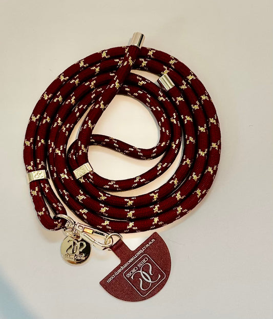 Goldline Phone Strap with durable woven gold thread design and universal adapter attached to a smartphone