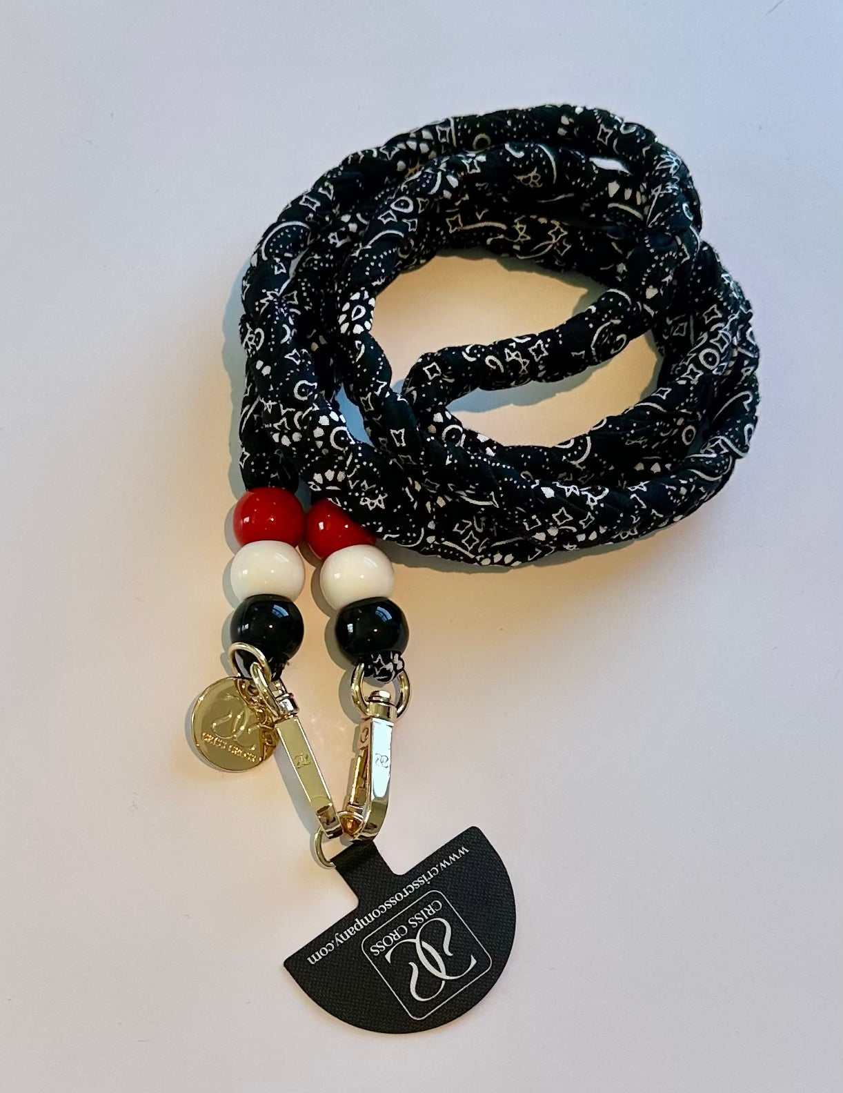 Bandana phone strap with universal adapter and bead details attached to phone case
