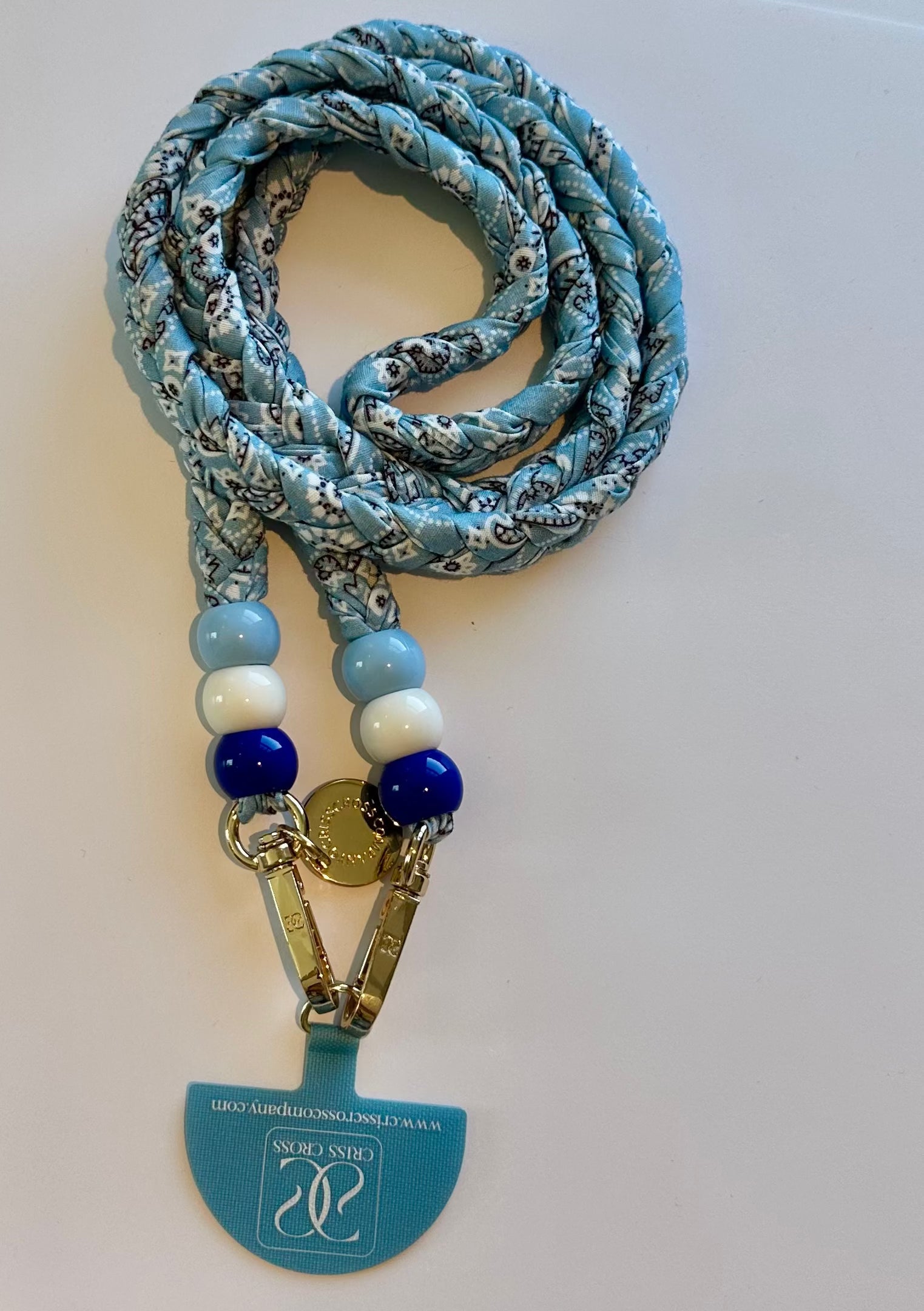 Bandana phone strap with soft cotton pattern, beads, and universal adapter attached to smartphone