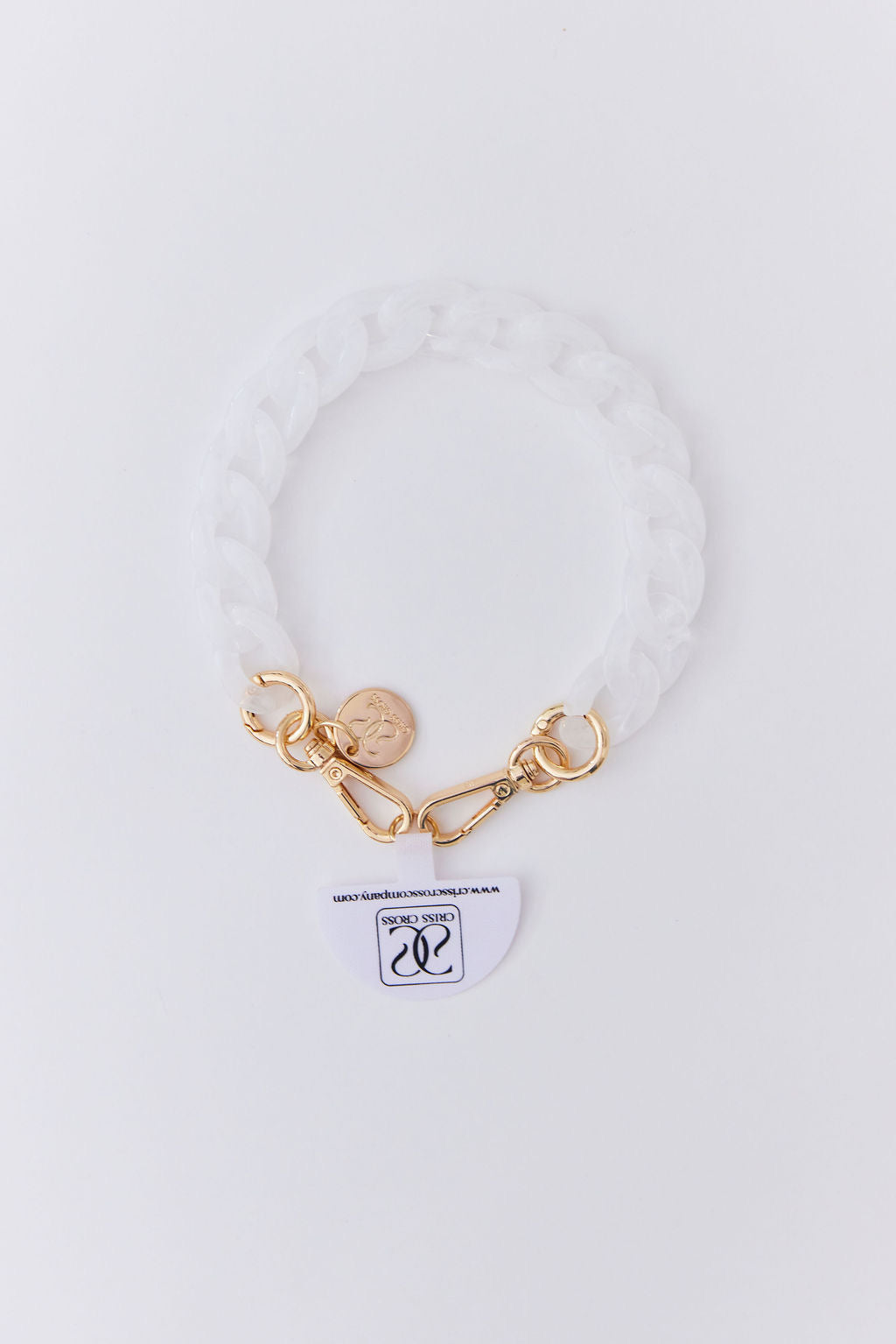 Detachable white acrylic phone wristlet with gold clasps and charm for hands-free use