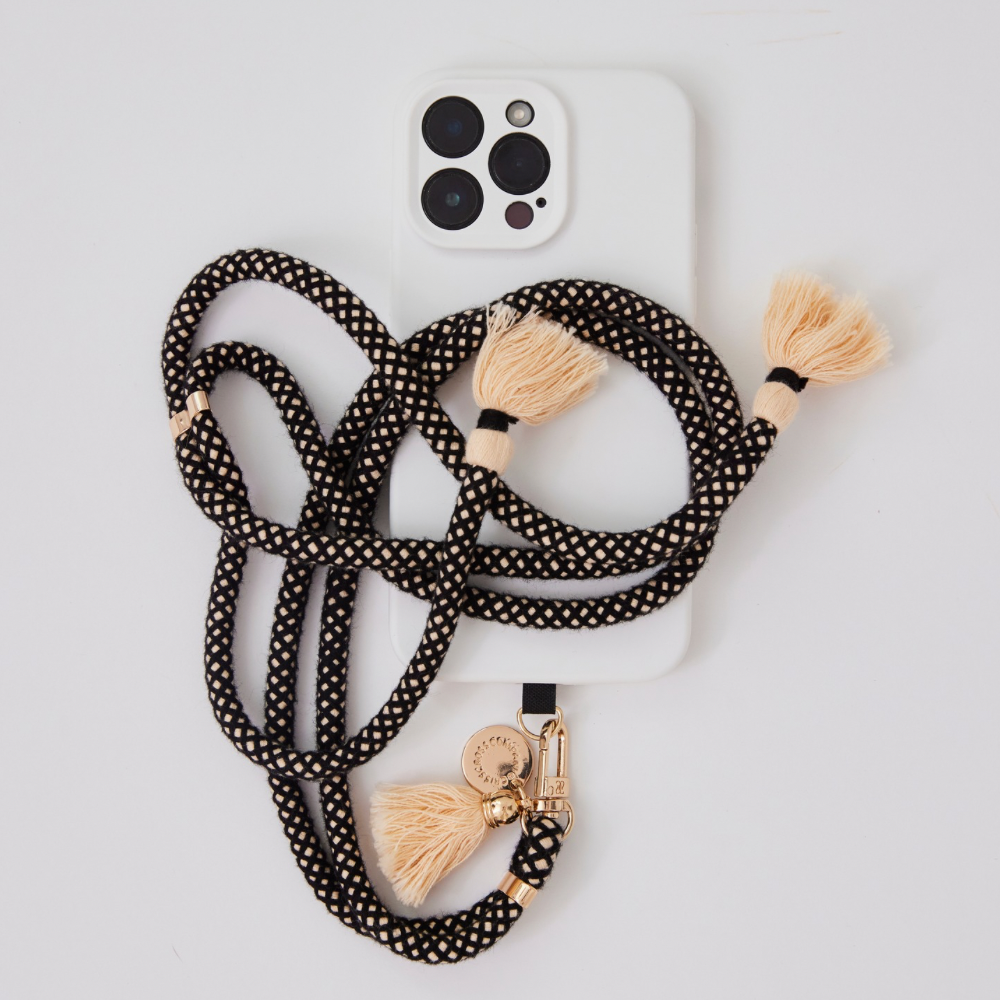 Adjustable cotton phone strap with universal phone adapter and decorative tassels for hands-free carrying