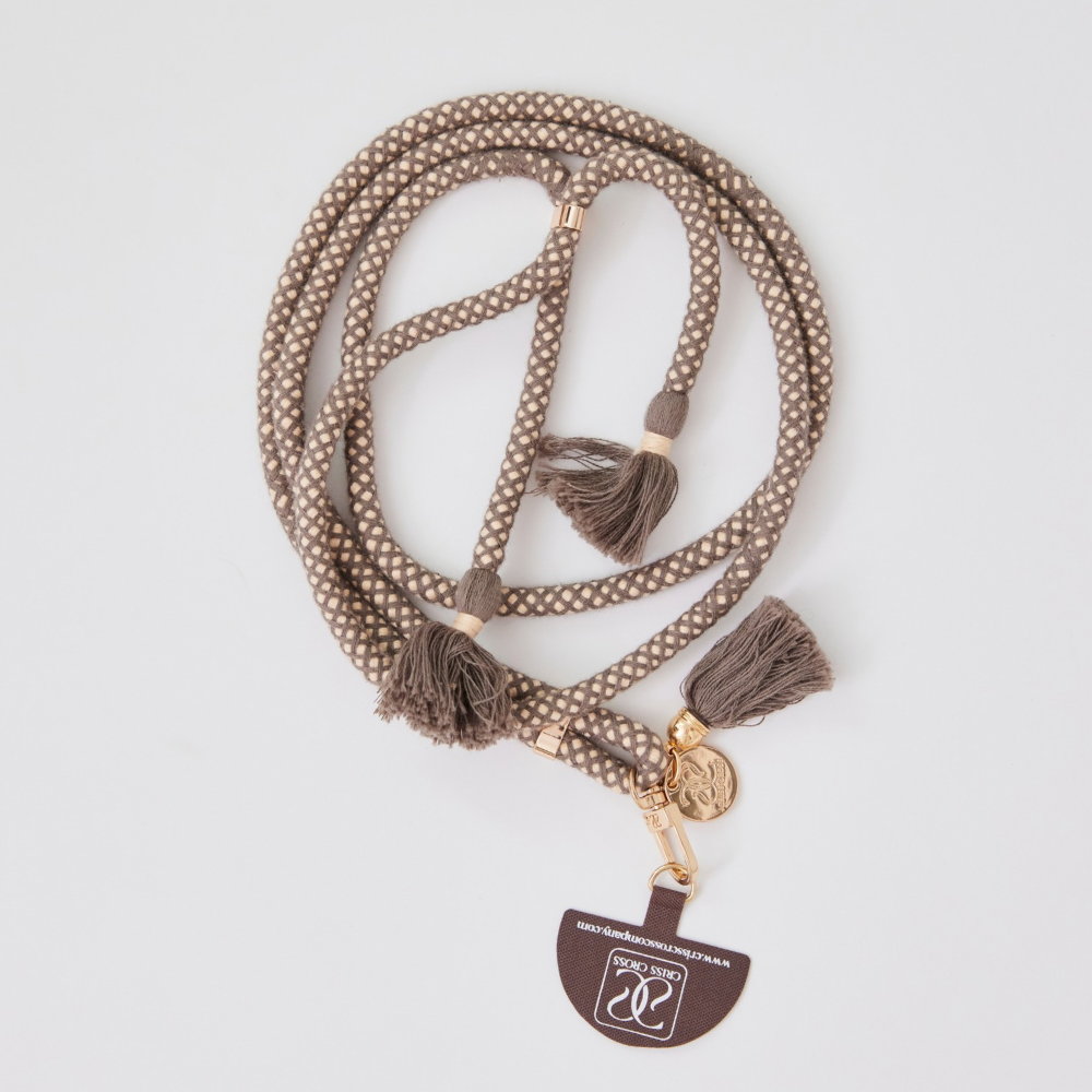 Adjustable cotton phone strap with universal phone adapter and decorative tassels for hands-free carrying